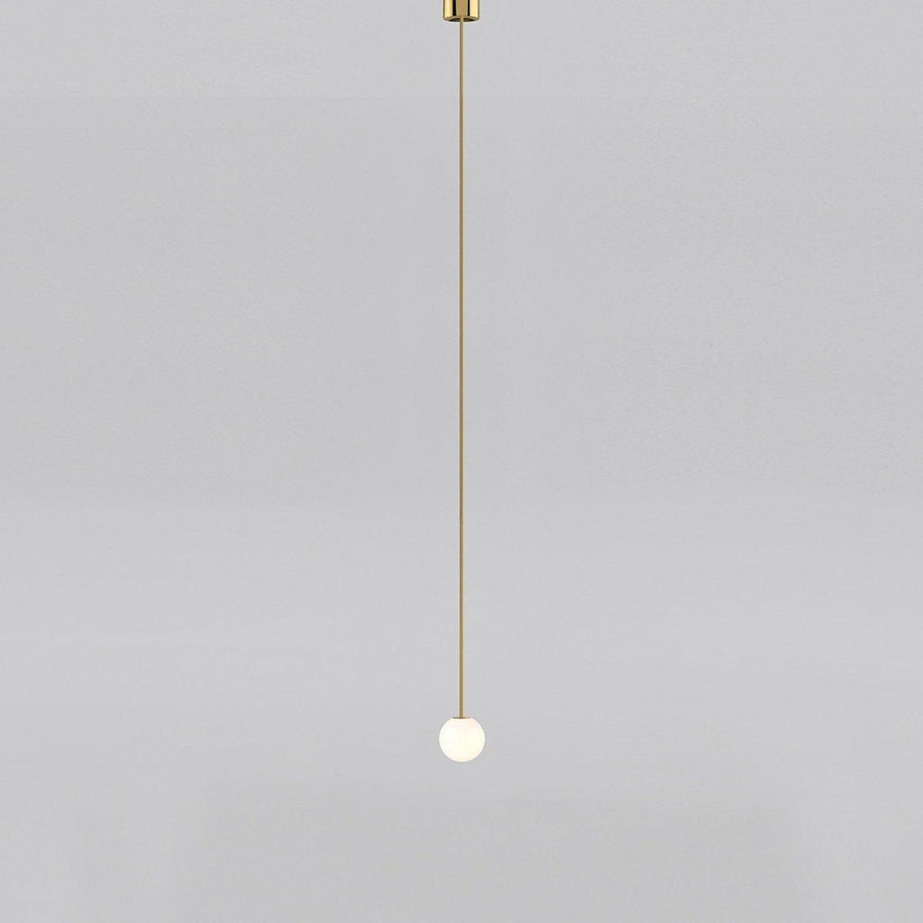 Opal glass globe pendant light shown from below on brass rod