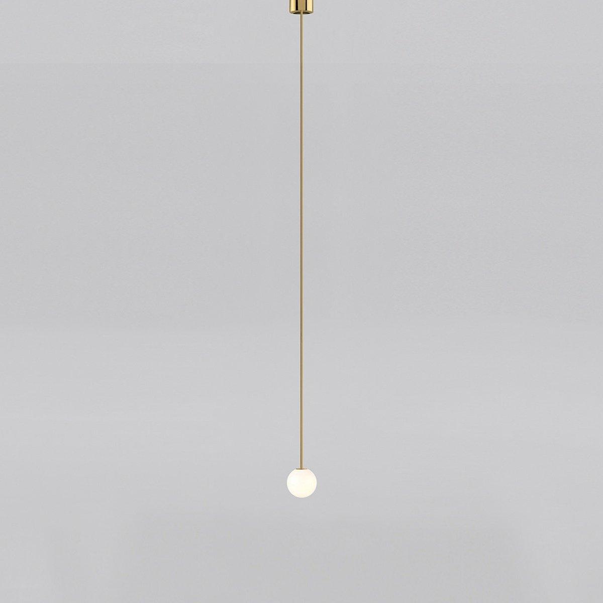 Opal glass globe pendant light shown from below on brass rod