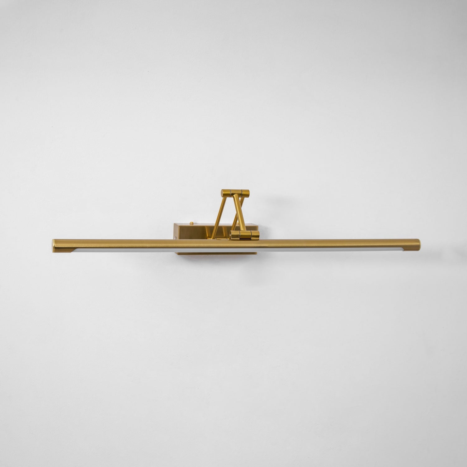 Gold frame light highlighting artwork with a soft warm glow