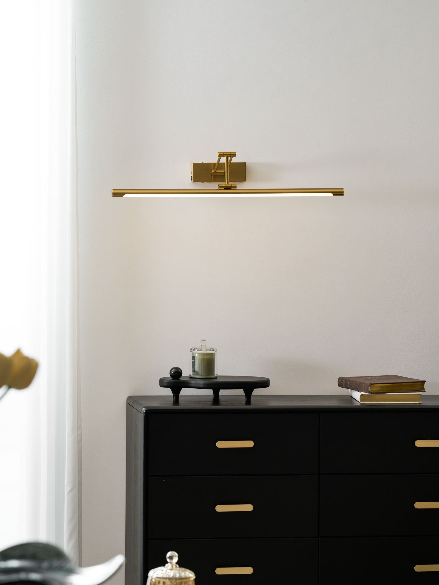 Rechargeable gold frame light casting glare-free light on a painting