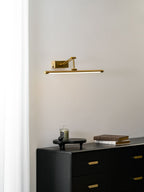 Slim gold LED picture light mounted above a framed print