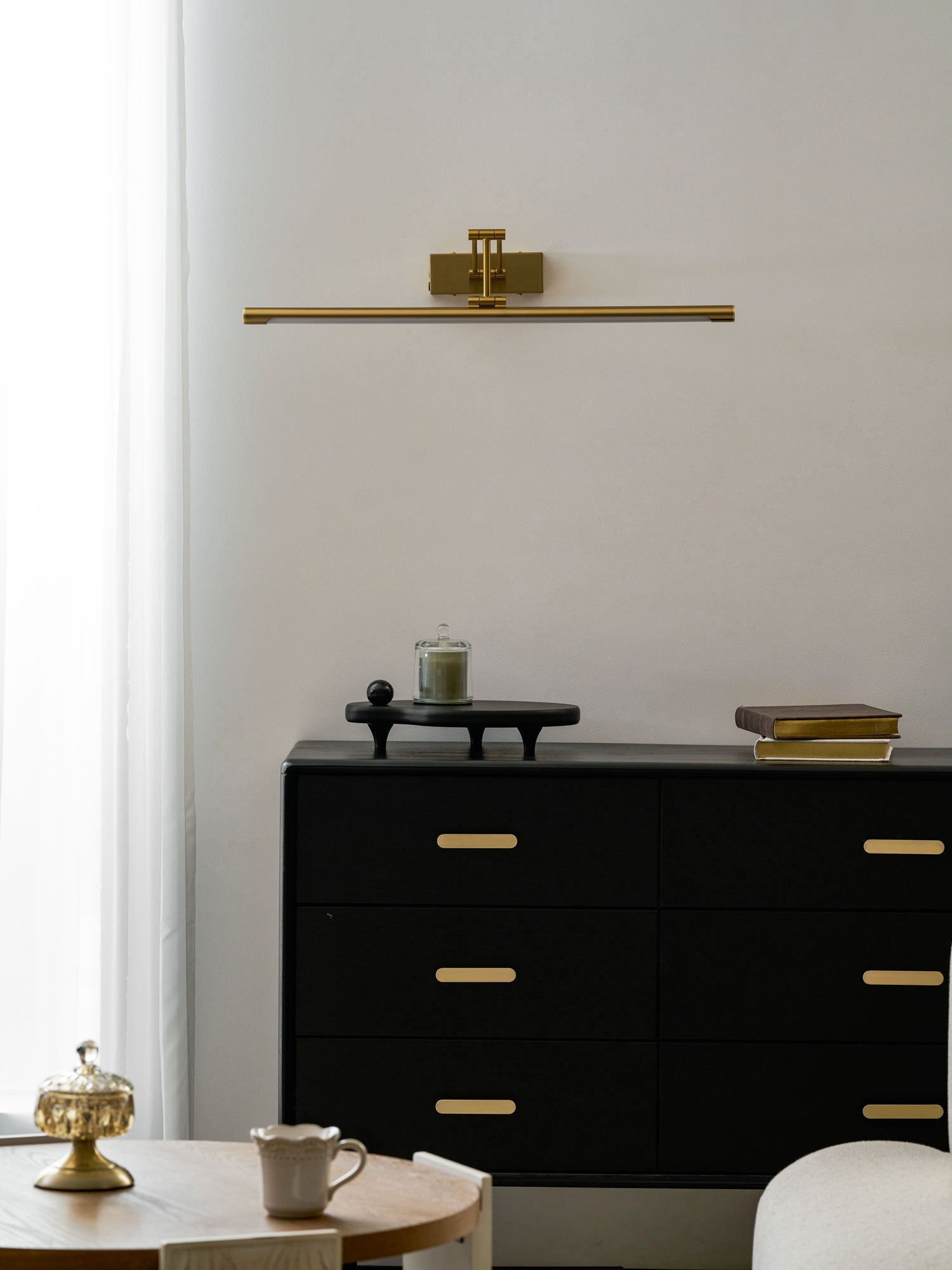 Gold frame light with touch dimmer lighting a painting warmly