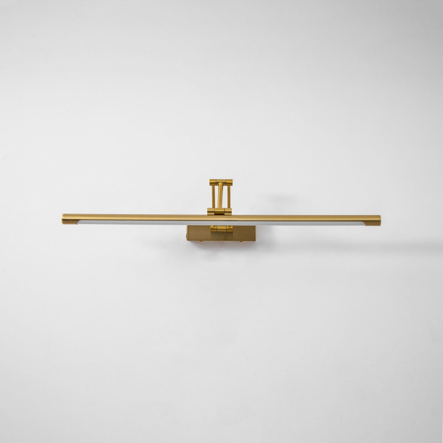 Slim gold LED picture light mounted above a framed picture