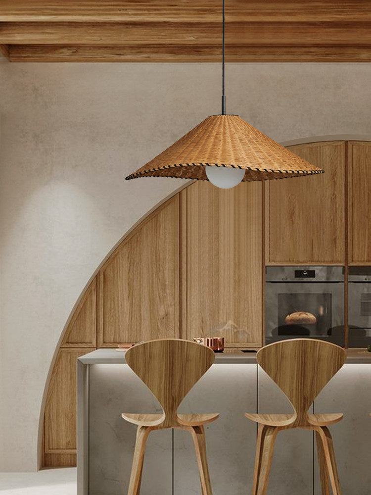 This lit Clérachic pendant hangs beneath a curved archway in a wood-panelled kitchen with bar stools.