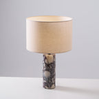 A taller crop shows more of the column base on this Clérachic marble lamp, set against plain grey.
