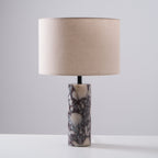 Framed slightly tighter than the front-on shot, the Clérachic marble lamp stands on a plain grey studio background.