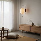 Bubble ball wall sconce with white shade styled in a warm interior