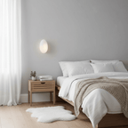 Pebble glass wall lamp glowing softly in a styled room