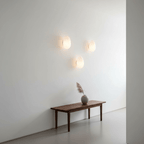 Glass wall lamp glowing gently in a warm interior corner