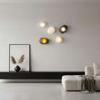Pebble glass wall lamp with a smooth translucent shade detail