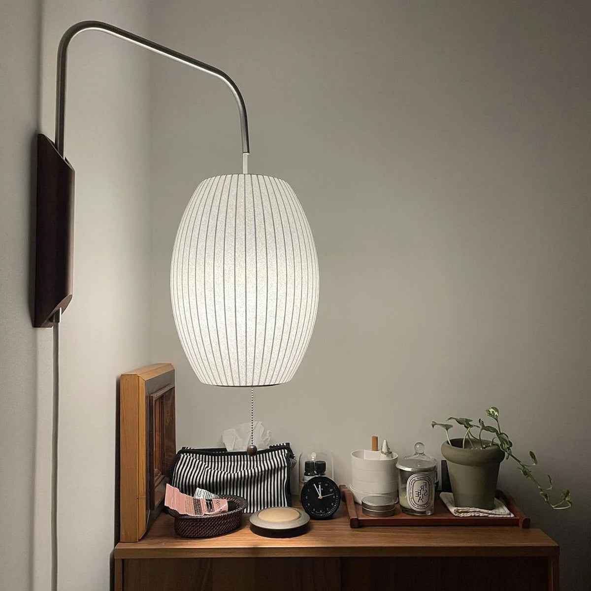 Bubble ball wall sconce with white shade and walnut accent detail