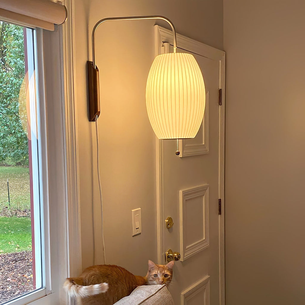 White polymer ball wall sconce styled against a clean neutral wall