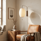 Round white sphere wall sconce on plain background showing full form