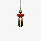 Coloured glass jar pendant lights arranged in a row