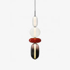 Mixed colour glass jar pendant lights glowing softly