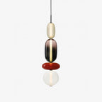 Tinted glass jar pendant light hanging from a black cable