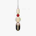 Coloured glass pendant lights hung at staggered heights