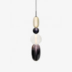 Glass jar pendant lights clustered above a seating area