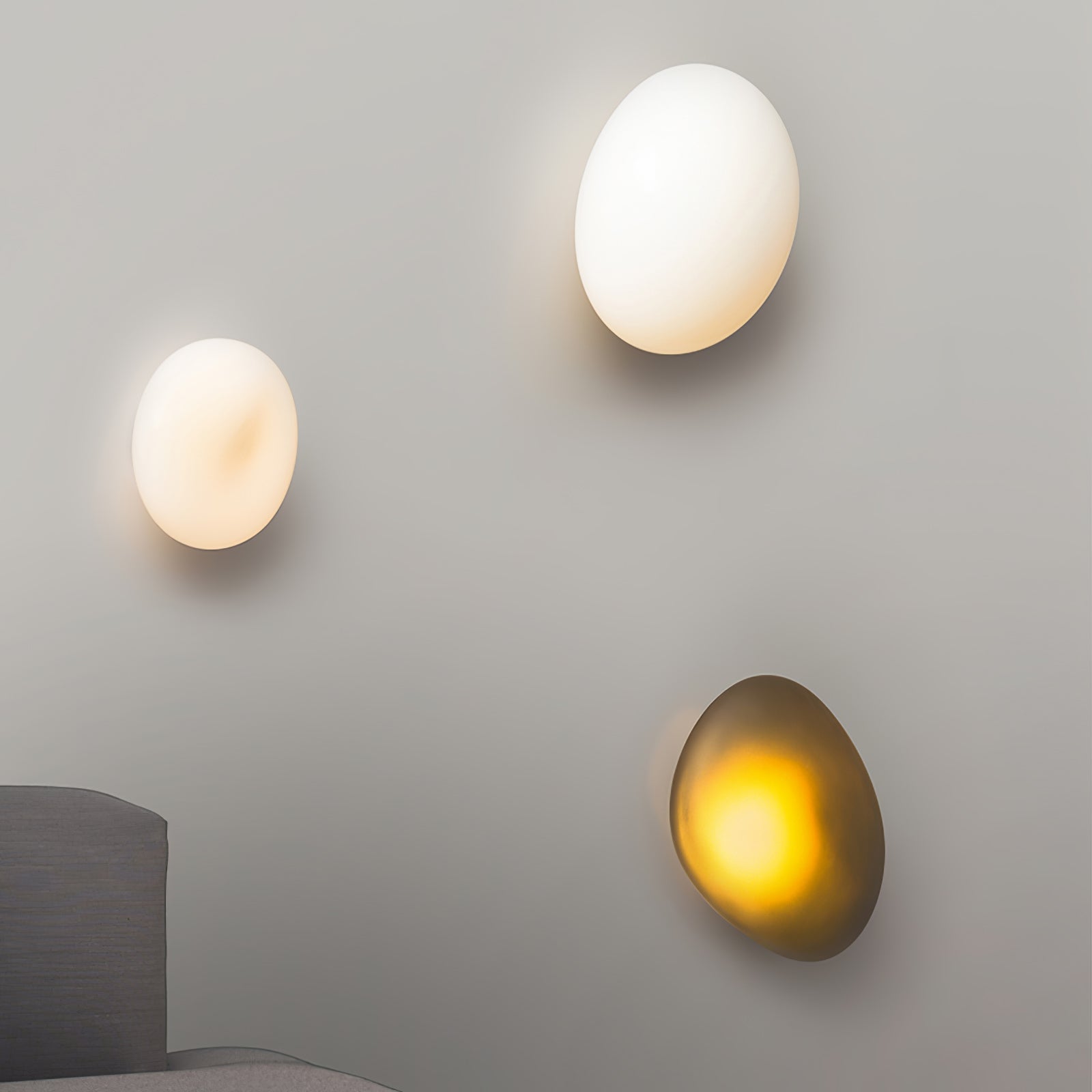 Pebble glass wall lamp shown close-up with soft warm light