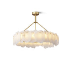 Burton round chandelier at a slight angle, warm light spilling between overlapping stone plates