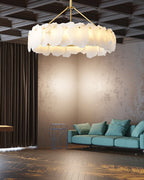 Burton chandelier under a coffered ceiling, lighting a lounge with a teal sofa and wood floor