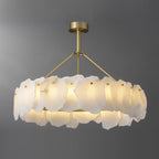 Burton alabaster chandelier lit against a grey backdrop, showing the full round brass ring frame