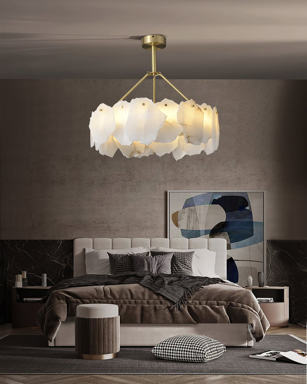Burton chandelier casting warm light in a bedroom with a concrete wall and abstract artwork