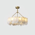 Front view of the Burton alabaster chandelier, brass canopy and stem above a lit ring of stone