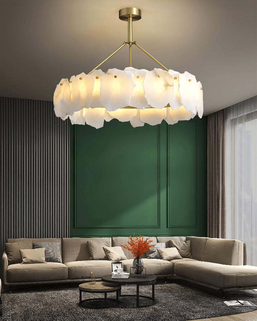 Burton chandelier above a beige sectional sofa, set against a deep green panelled wall
