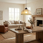 Over a reclaimed-wood coffee table in a living room with a brown sofa, this Clérachic pendant's quilted shade glows warm.