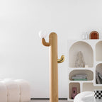 Pale-wood Clérachic floor lamp glows beside arched wall niches holding ceramics and a boucle ottoman.