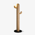 Pale-wood Clérachic floor lamp on a light grey studio background, glass orb lit, cord trailing from the round base.