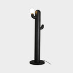 Black-finished Clérachic floor lamp with a lit glass orb, photographed against a plain grey studio background.