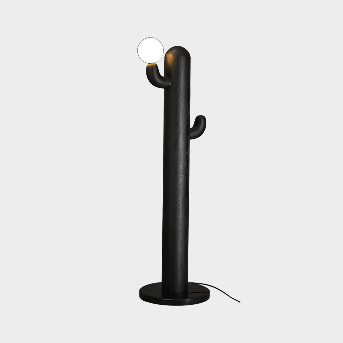 Black-finished Clérachic floor lamp with a lit glass orb, photographed against a plain grey studio background.