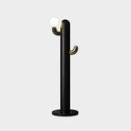 Black-finished Clérachic floor lamp with a lit glass orb, shown isolated on a plain grey studio background.