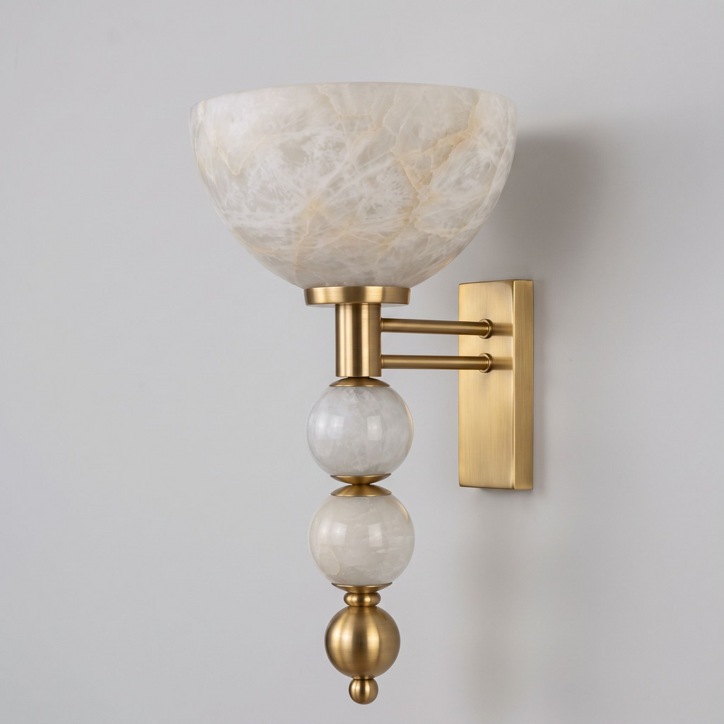This Clérachic sconce in brushed brass shows its upward alabaster bowl stacked above two alabaster spheres.