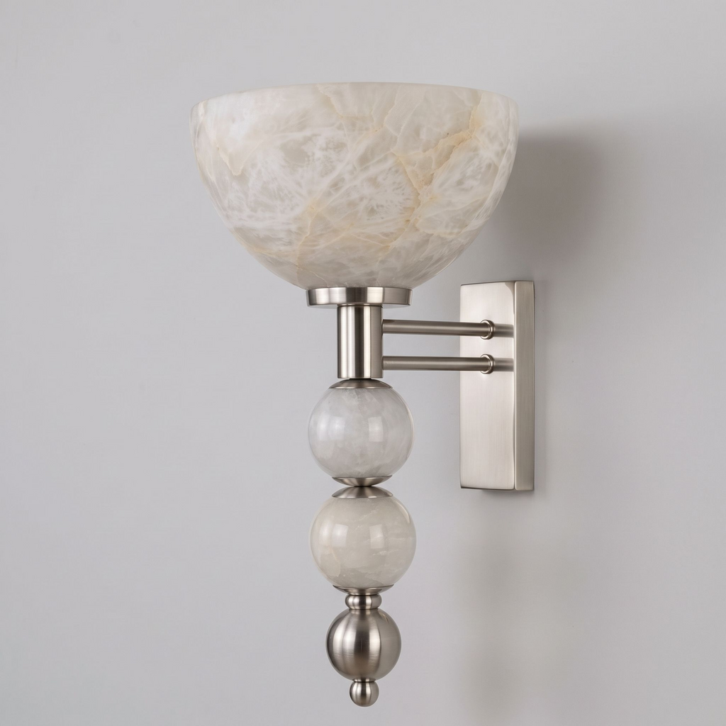 In brushed nickel, this Clérachic sconce stands alone against grey, its alabaster spheres stacked beneath the bowl.