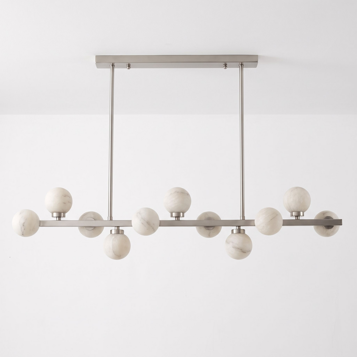 Studio shot of this Clérachic chandelier in brushed nickel, alabaster balls alternating above and below the bar.