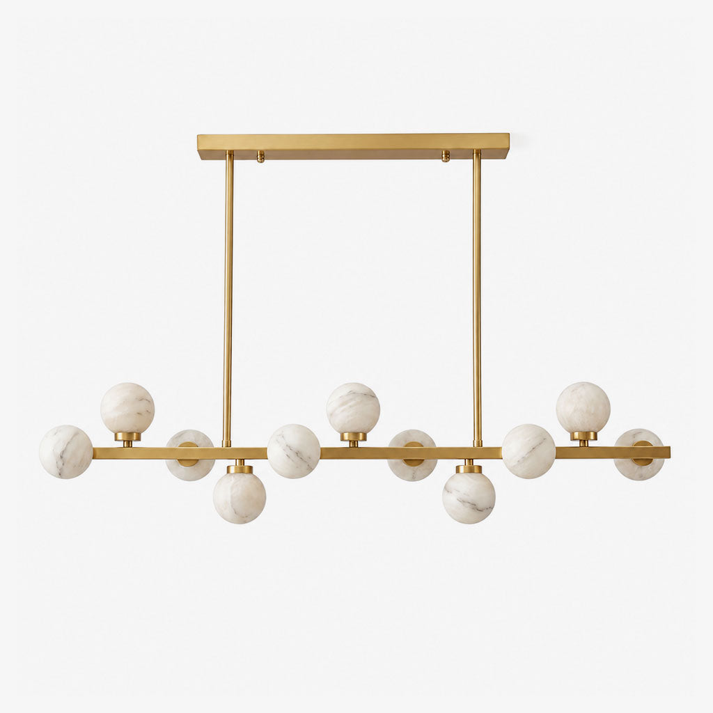 Studio view of this Clérachic chandelier in brushed brass, alabaster balls staggered along a straight bar.