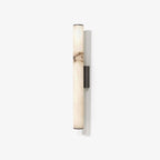 Alabaster wall sconce lit against a warm neutral wall