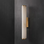 Tall alabaster wall sconce on a brass arm in a hallway