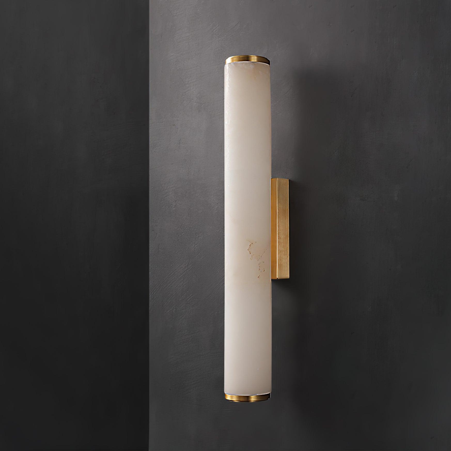 Tall alabaster wall sconce on a brass arm in a hallway