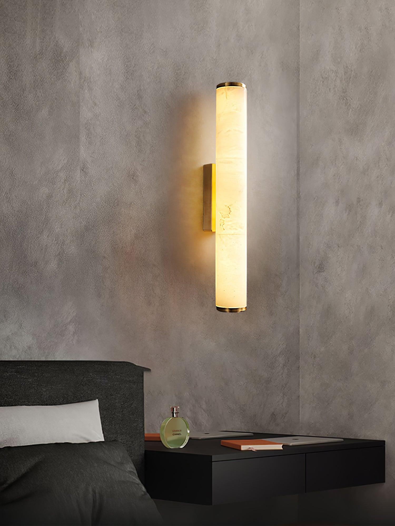 Matte black alabaster wall sconce mounted in a cozy reading nook