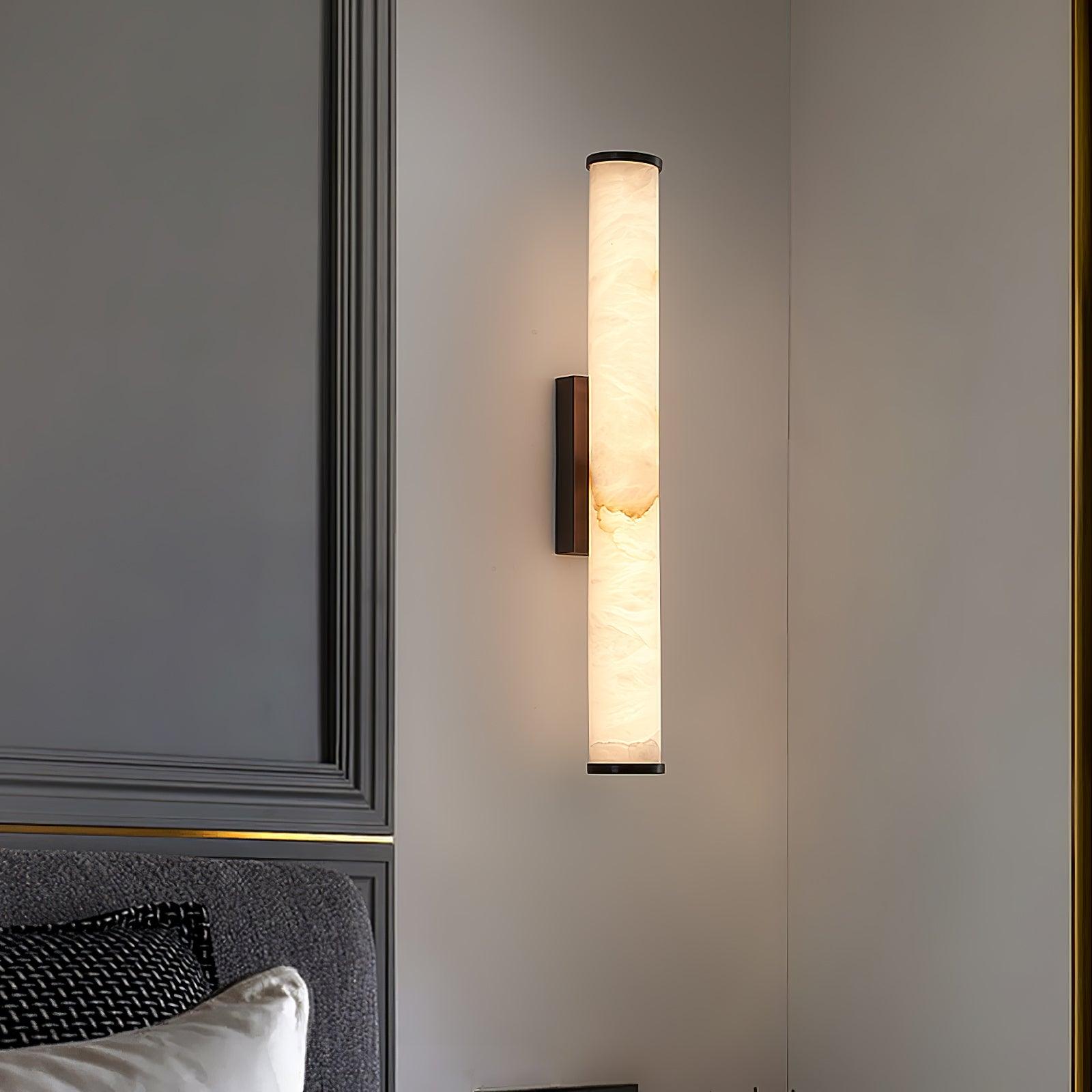 Brass alabaster wall sconce paired beside a tall window
