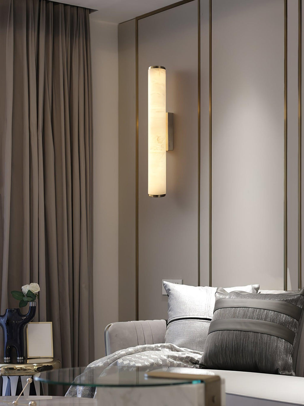 Alabaster wall sconce casting a gentle glow on a corridor wall