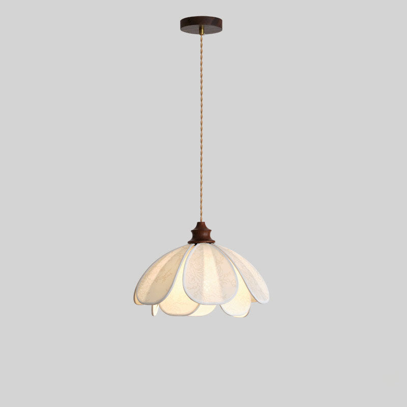Against a plain grey backdrop, this unlit Clérachic pendant shows its coiled cord and fabric petal shade.