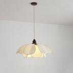 Suspended from a straight cord on a plain wall, this Clérachic pendant's fabric petals glow softly.