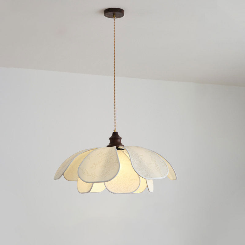 Suspended from a straight cord on a plain wall, this Clérachic pendant's fabric petals glow softly.