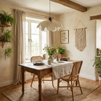 Hanging plants and a macramé accent frame this lit Clérachic pendant above a linen-draped dining table.