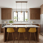 A linear Clérachic pendant with travertine spheres and glass globes spans a kitchen island with mustard-yellow stools.